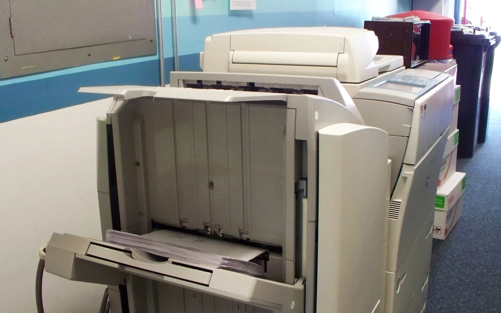 An office copier with its side panel open for service